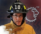 Steve Schwartz ’84 in firefighting gear with a smoke simulator.